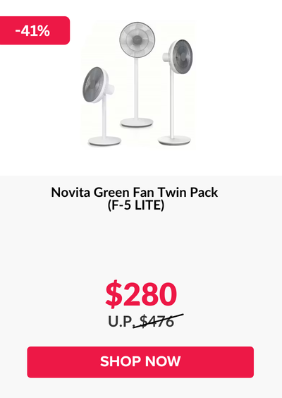 Woman wearing an olive green blazer and light blue jeans walking in an urban setting.