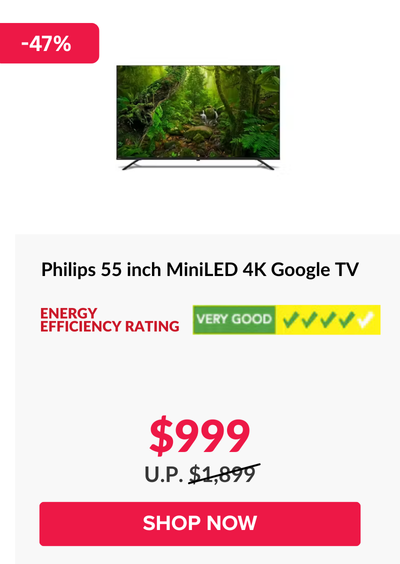 Man in a gray blazer over a dark gray shirt standing on stairs in an urban background.