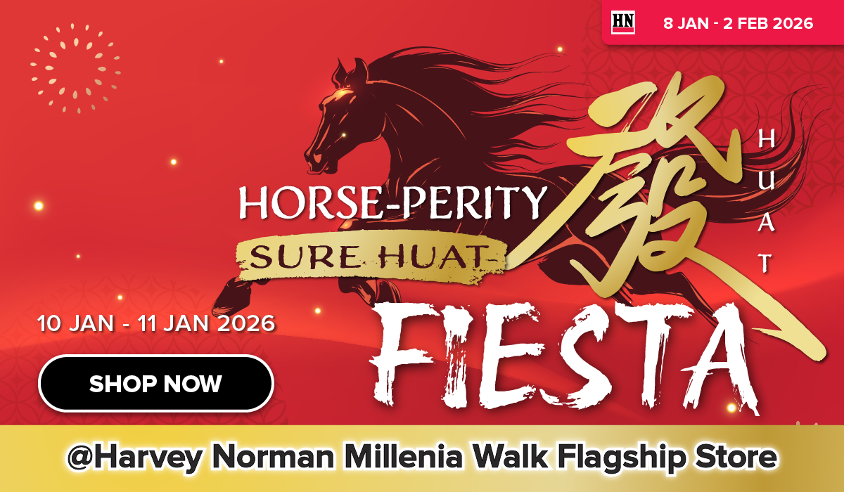 Woman wearing an olive green blazer and light blue jeans walking in an urban setting.