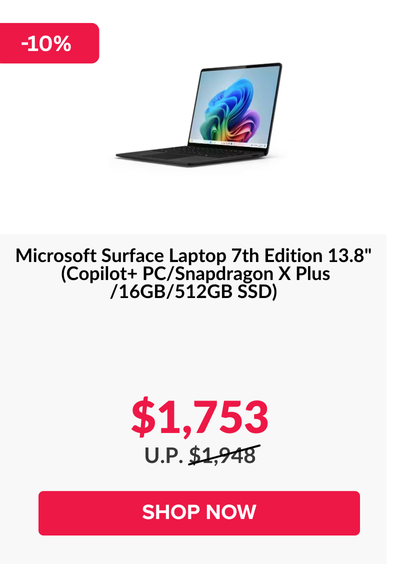 Man in a gray blazer over a dark gray shirt standing on stairs in an urban background.