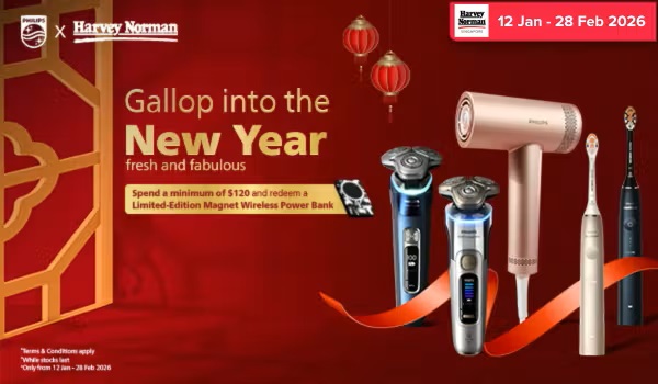 Woman wearing an olive green blazer and light blue jeans walking in an urban setting.