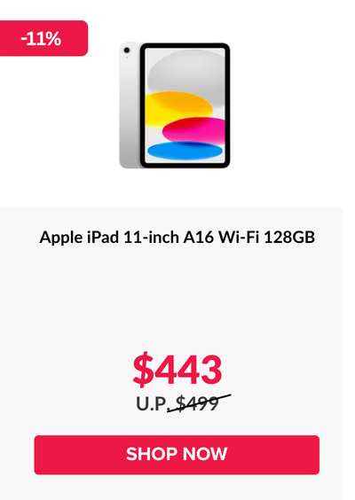 Woman wearing an olive green blazer and light blue jeans walking in an urban setting.