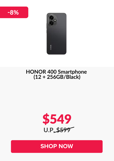 Man in a gray blazer over a dark gray shirt standing on stairs in an urban background.