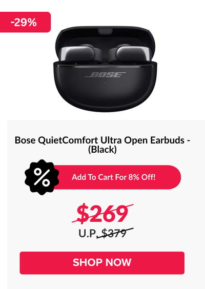 Woman wearing an olive green blazer and light blue jeans walking in an urban setting.