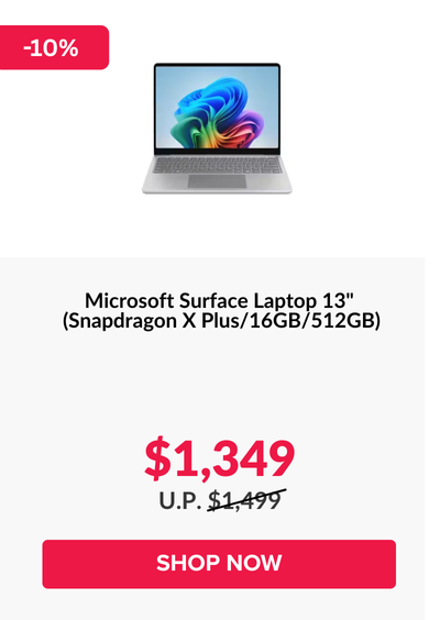 Man in a gray blazer over a dark gray shirt standing on stairs in an urban background.