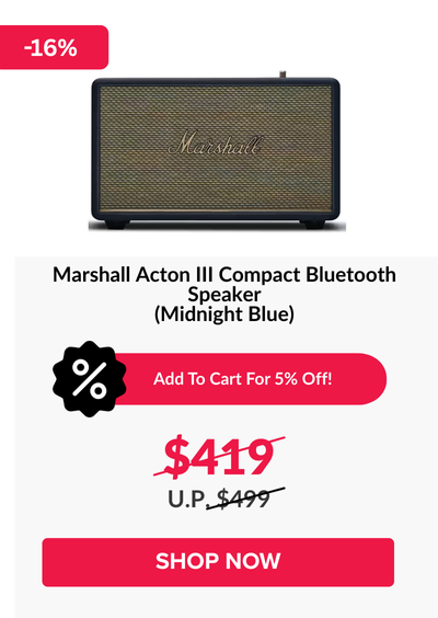 Woman wearing an olive green blazer and light blue jeans walking in an urban setting.