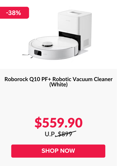 Man in a gray blazer over a dark gray shirt standing on stairs in an urban background.