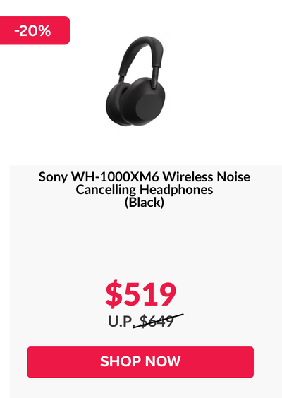 Woman wearing an olive green blazer and light blue jeans walking in an urban setting.