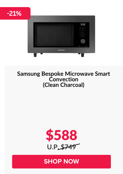 Woman wearing an olive green blazer and light blue jeans walking in an urban setting.