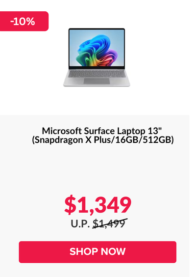 Man in a gray blazer over a dark gray shirt standing on stairs in an urban background.