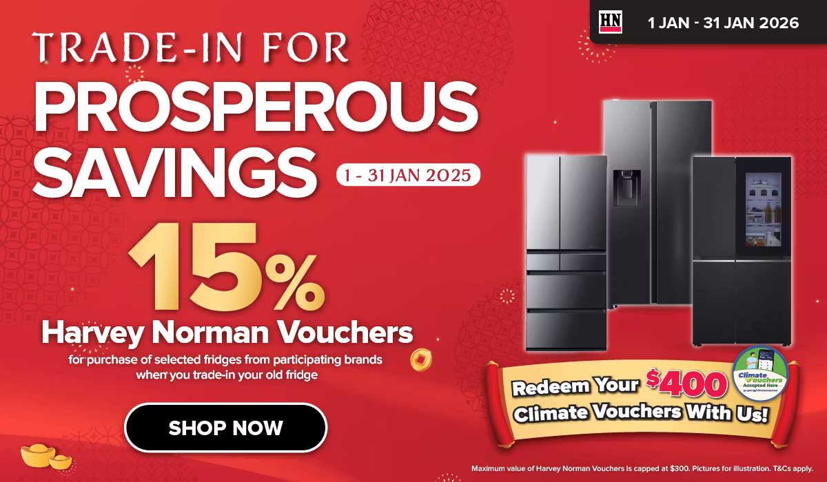 Man in a gray blazer over a dark gray shirt standing on stairs in an urban background.