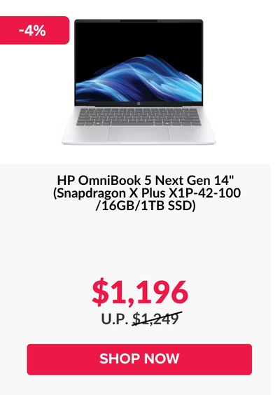 Man in a gray blazer over a dark gray shirt standing on stairs in an urban background.