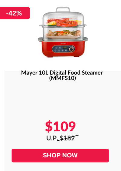 Woman wearing an olive green blazer and light blue jeans walking in an urban setting.