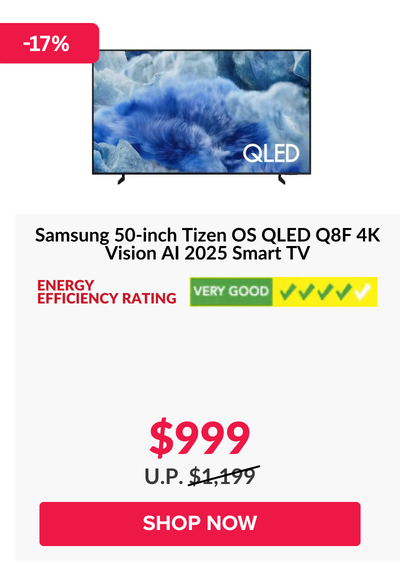 Man in a gray blazer over a dark gray shirt standing on stairs in an urban background.