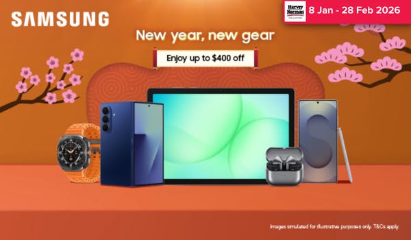 Woman wearing an olive green blazer and light blue jeans walking in an urban setting.