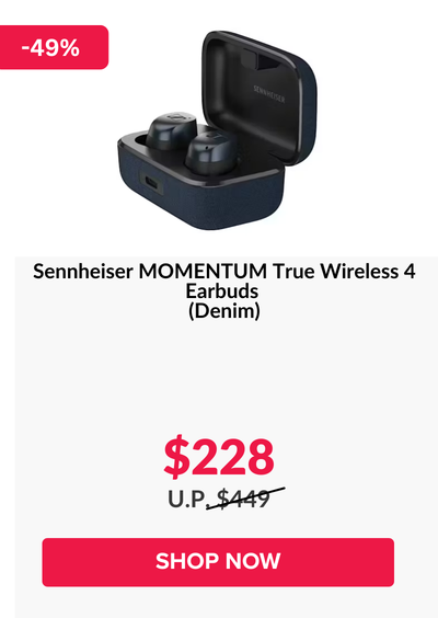 Woman wearing an olive green blazer and light blue jeans walking in an urban setting.