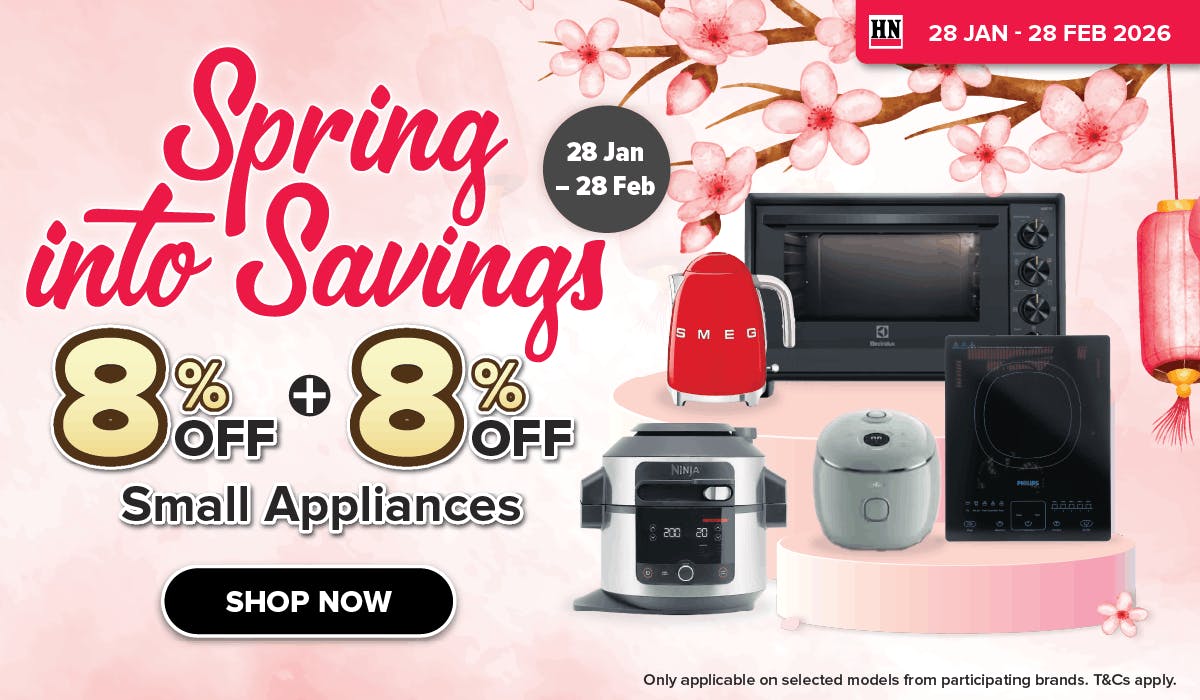 Woman wearing an olive green blazer and light blue jeans walking in an urban setting.