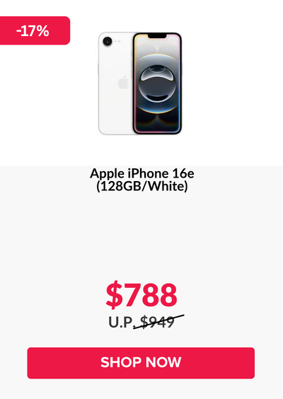 Woman wearing an olive green blazer and light blue jeans walking in an urban setting.