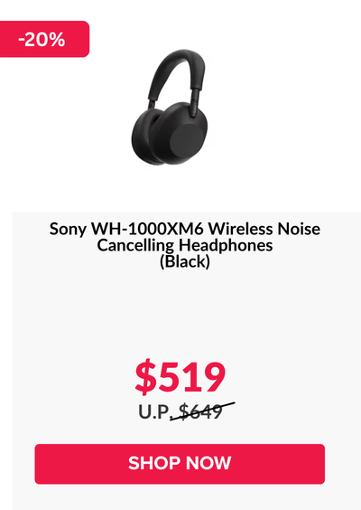 Woman wearing an olive green blazer and light blue jeans walking in an urban setting.