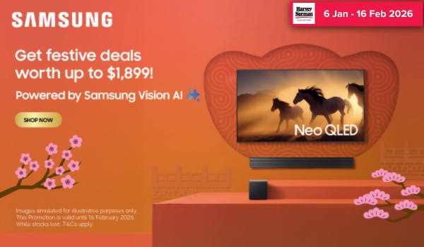 Woman wearing an olive green blazer and light blue jeans walking in an urban setting.