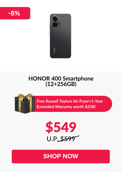 Man in a gray blazer over a dark gray shirt standing on stairs in an urban background.