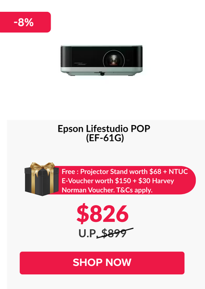 Woman wearing an olive green blazer and light blue jeans walking in an urban setting.