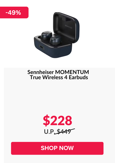 Woman wearing an olive green blazer and light blue jeans walking in an urban setting.