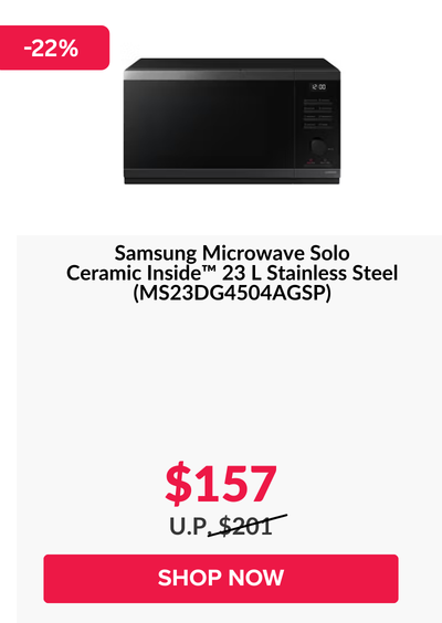 Woman wearing an olive green blazer and light blue jeans walking in an urban setting.