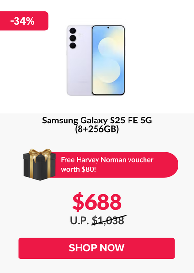 Man in a gray blazer over a dark gray shirt standing on stairs in an urban background.