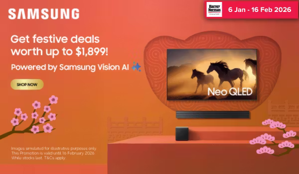 Woman wearing an olive green blazer and light blue jeans walking in an urban setting.