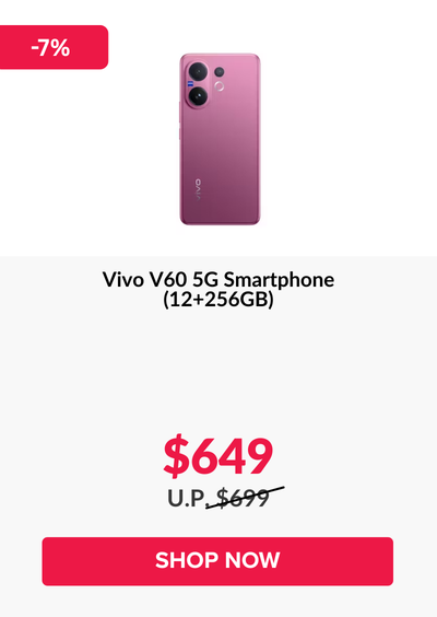 Man in a gray blazer over a dark gray shirt standing on stairs in an urban background.