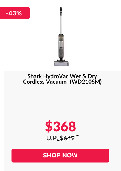 Woman wearing an olive green blazer and light blue jeans walking in an urban setting.