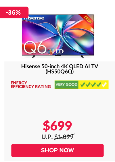 Man in a gray blazer over a dark gray shirt standing on stairs in an urban background.