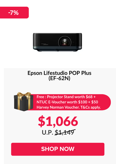 Woman wearing an olive green blazer and light blue jeans walking in an urban setting.