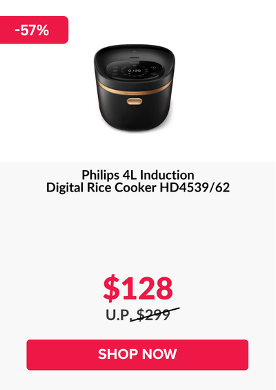 Man in a gray blazer over a dark gray shirt standing on stairs in an urban background.