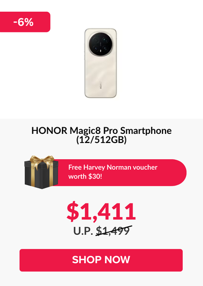 Man in a gray blazer over a dark gray shirt standing on stairs in an urban background.