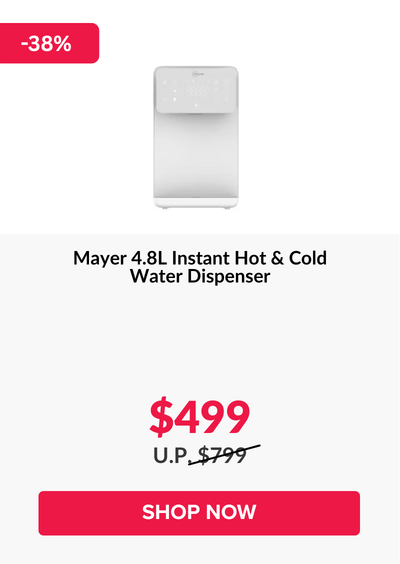 Man in a gray blazer over a dark gray shirt standing on stairs in an urban background.