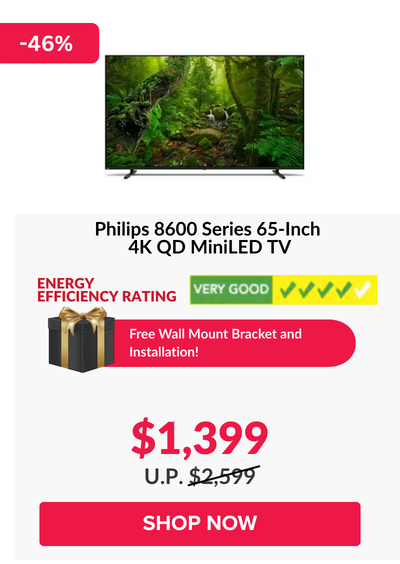 Man in a gray blazer over a dark gray shirt standing on stairs in an urban background.