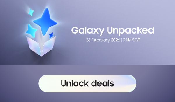 Woman wearing an olive green blazer and light blue jeans walking in an urban setting.