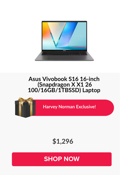 Man in a gray blazer over a dark gray shirt standing on stairs in an urban background.