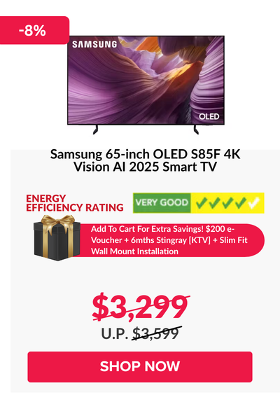 Man in a gray blazer over a dark gray shirt standing on stairs in an urban background.