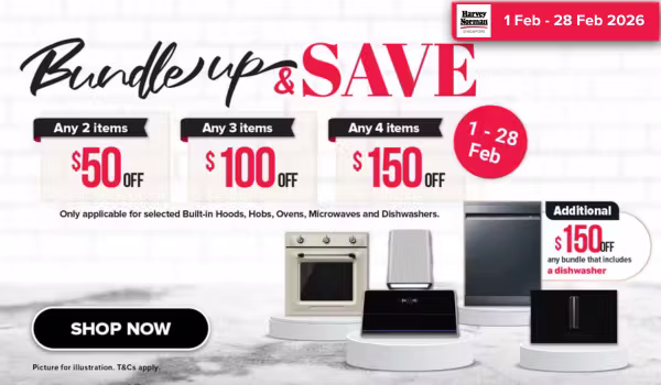 Woman wearing an olive green blazer and light blue jeans walking in an urban setting.