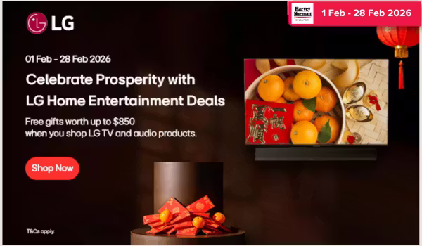 Man in a gray blazer over a dark gray shirt standing on stairs in an urban background.