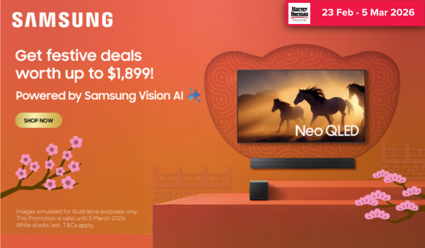 Woman wearing an olive green blazer and light blue jeans walking in an urban setting.