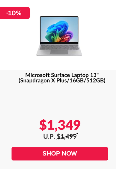 Man in a gray blazer over a dark gray shirt standing on stairs in an urban background.