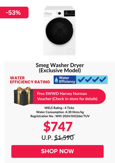 Woman wearing an olive green blazer and light blue jeans walking in an urban setting.