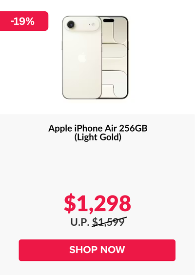 Woman wearing an olive green blazer and light blue jeans walking in an urban setting.