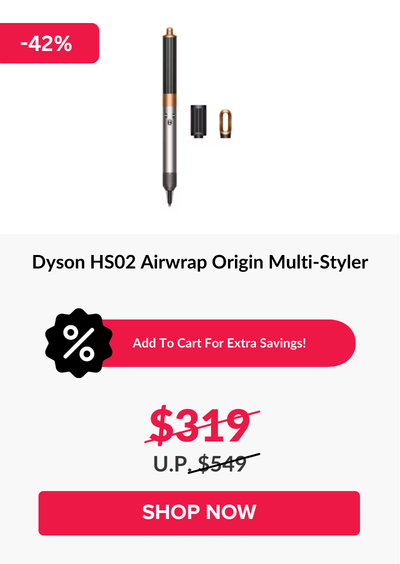 Man in a gray blazer over a dark gray shirt standing on stairs in an urban background.