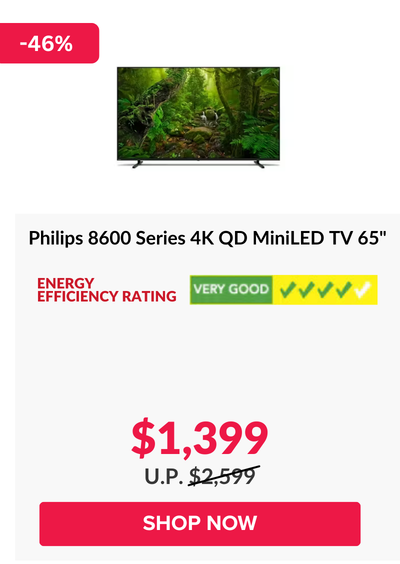 Man in a gray blazer over a dark gray shirt standing on stairs in an urban background.