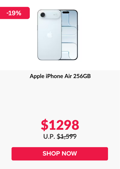 Woman wearing an olive green blazer and light blue jeans walking in an urban setting.